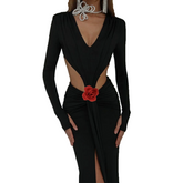 Black dress with a red flower detail on a white background